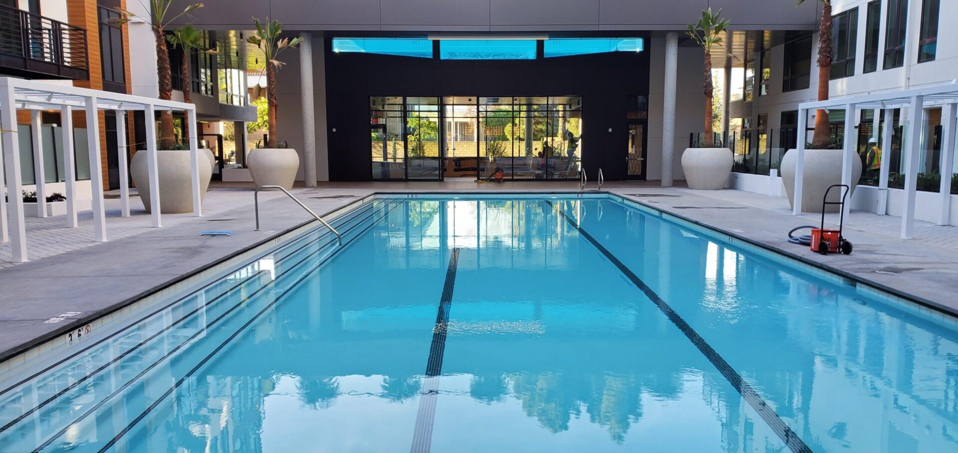 A swimming pool with a large window in the middle of it.