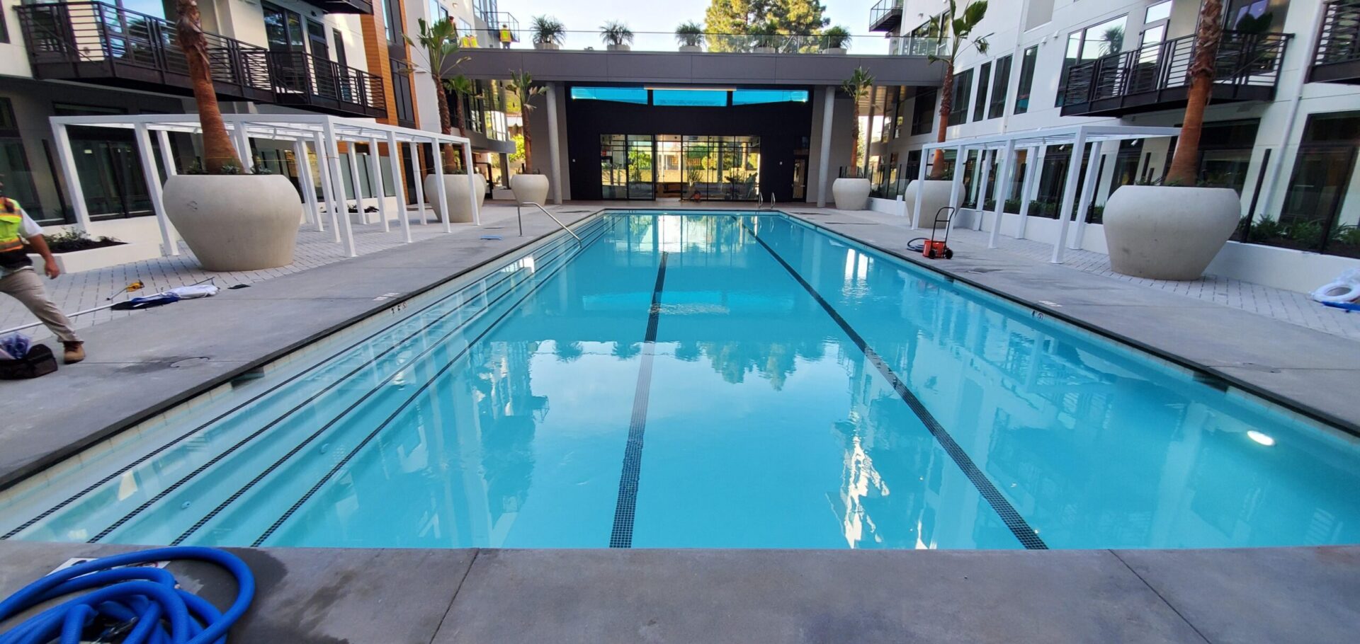 A large swimming pool with chairs around it